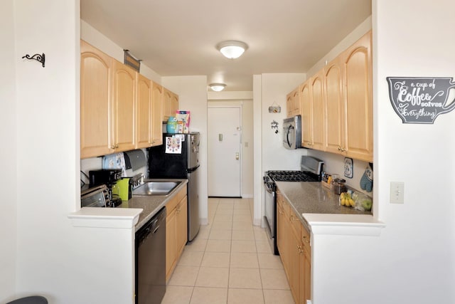 kitchen featuring light brown cabinets, light tile patterned floors, stainless steel appliances, and sink