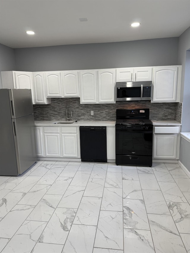 kitchen featuring black appliances, backsplash, white cabinets, and sink