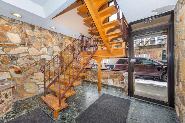 stairway featuring concrete floors