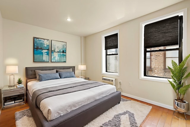 108 Waldo Ave Unit 4B, Jersey City, NJ 07306 - bedroom featuring hardwood / wood-style floors, recessed lighting, and an AC wall unit