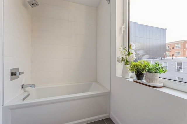 bathroom with tile patterned floors and bathing tub / shower combination