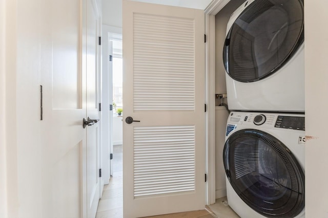 clothes washing area featuring stacked washer / drying machine