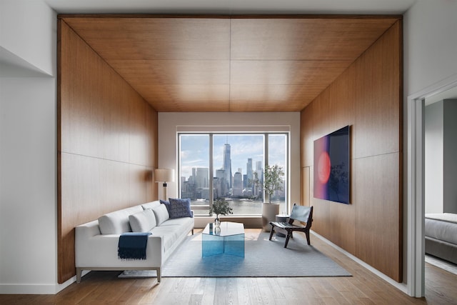 living room featuring wooden walls, hardwood / wood-style flooring, and wooden ceiling