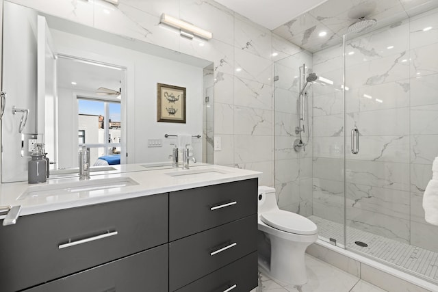 bathroom featuring marble finish floor, a marble finish shower, vanity, and toilet