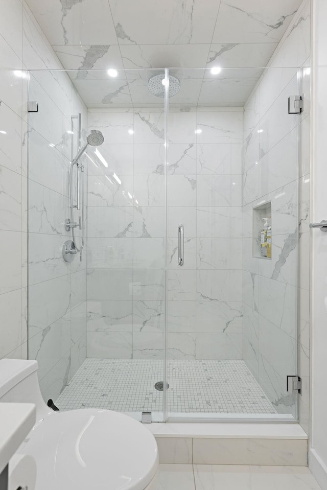 full bath with a shower stall and toilet