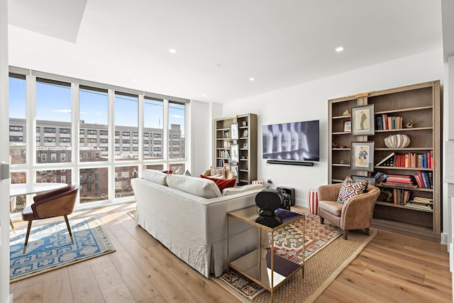 living room with wood-type flooring, recessed lighting, and expansive windows