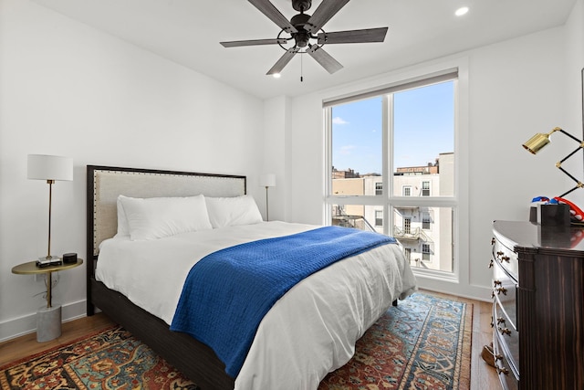 bedroom featuring wood finished floors, ceiling fan, baseboards, and recessed lighting
