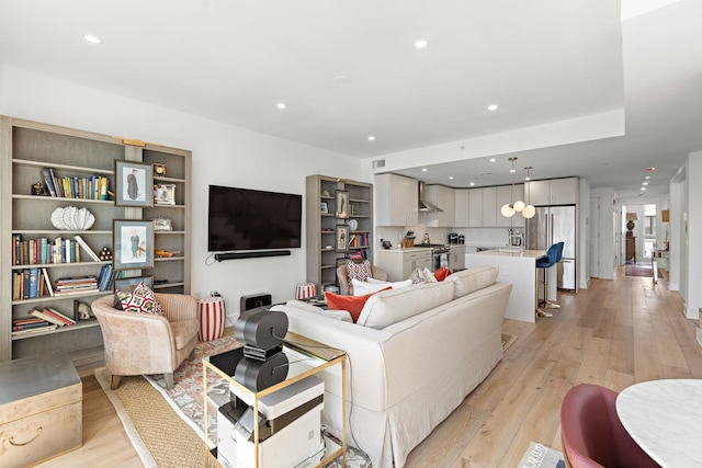 living area featuring recessed lighting and light wood finished floors