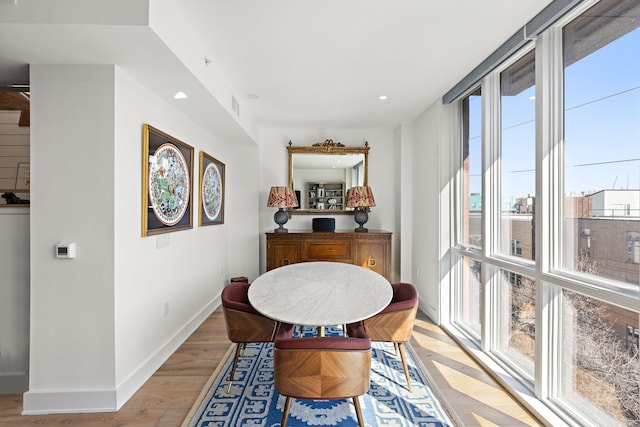 dining space with light wood-type flooring, baseboards, and recessed lighting