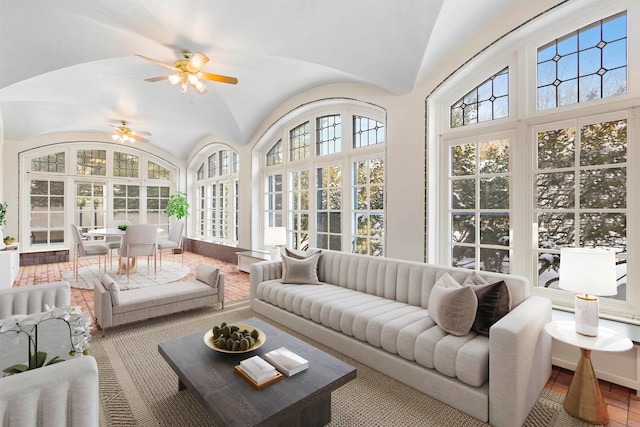 sunroom / solarium with lofted ceiling and ceiling fan