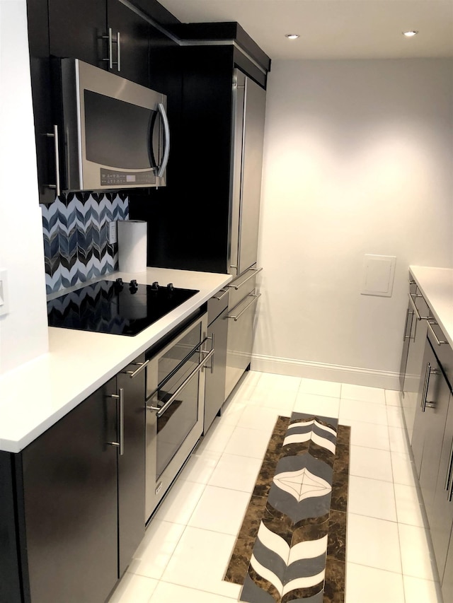 20 2nd St Unit 503, Jersey City, NJ 07302 - kitchen with appliances with stainless steel finishes, light countertops, tasteful backsplash, dark cabinets, and recessed lighting