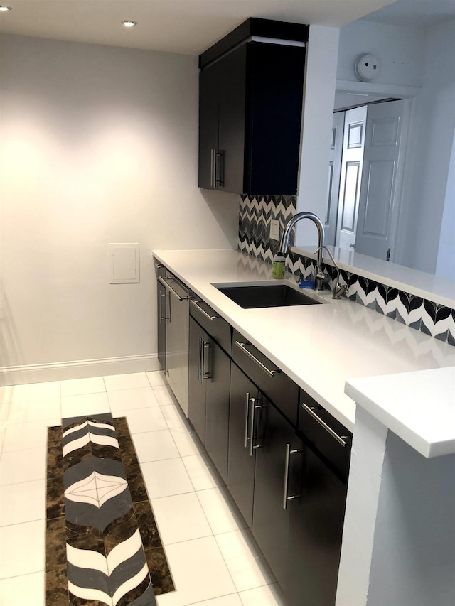20 2nd St Unit 503, Jersey City, NJ 07302 - kitchen with light countertops, a peninsula, dark cabinetry, recessed lighting, and light tile patterned floors