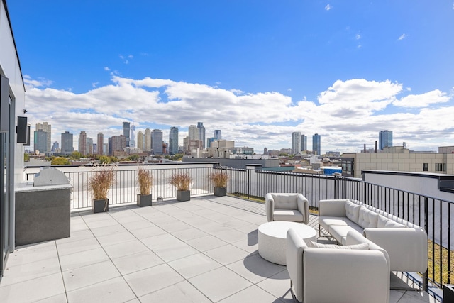 view of patio / terrace with an outdoor living space and a city view