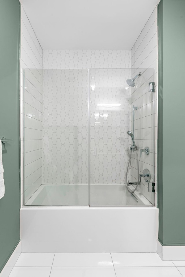 bathroom with washtub / shower combination and tile patterned floors