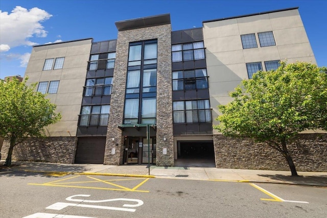 view of building exterior featuring uncovered parking