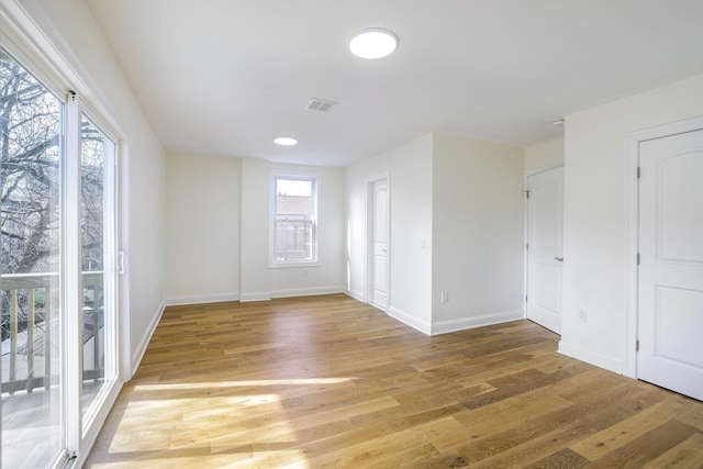 unfurnished room with wood-type flooring