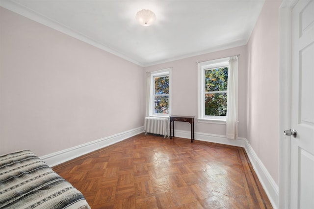 interior space with radiator, crown molding, and dark parquet floors