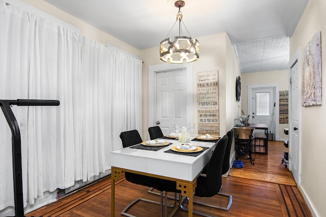 office with an inviting chandelier and dark hardwood / wood-style floors