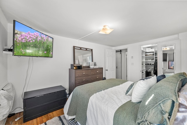 607 1st St Unit 1, Hoboken, NJ 07030 - bedroom featuring wood finished floors, a walk in closet, and a closet