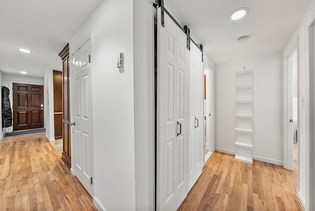 607 1st St Unit 1, Hoboken, NJ 07030 - hall with a barn door, light wood-style floors, recessed lighting, and baseboards