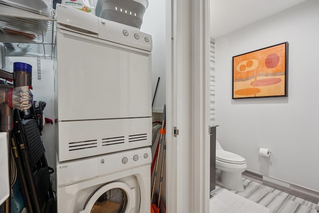 2 2nd St Unit 3103, Jersey City, NJ 07302 - laundry room featuring estacked washer and dryer, baseboards, and wood finished floors
