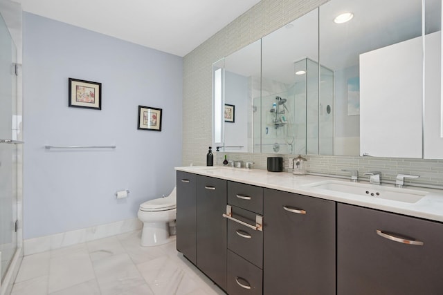 2 2nd St Unit 3103, Jersey City, NJ 07302 - bathroom featuring double vanity, a shower stall, toilet, baseboards, and backsplash