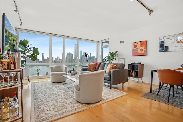 2 2nd St Unit 3103, Jersey City, NJ 07302 - living area featuring track lighting, wood finished floors, healthy amount of natural light, and expansive windows