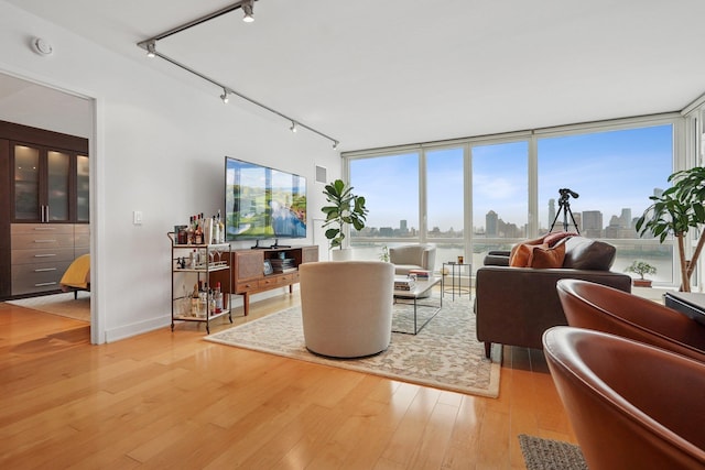 2 2nd St Unit 3103, Jersey City, NJ 07302 - living room with track lighting, light wood-style flooring, and healthy amount of natural light