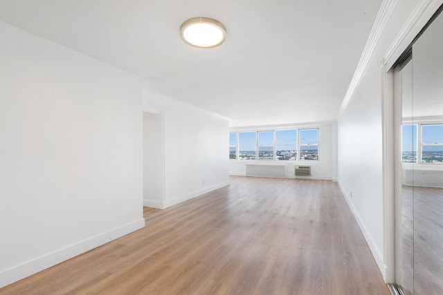 10 Huron Ave Unit 17F, Jersey City, NJ 07306 - unfurnished living room featuring ornamental molding, plenty of natural light, light wood-style flooring, and baseboards