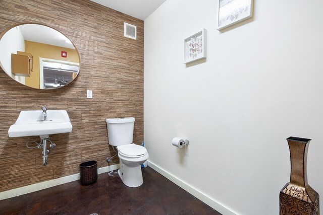 10 Huron Ave Unit 17F, Jersey City, NJ 07306 - half bathroom with toilet, baseboards, a sink, and tile walls
