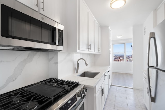 10 Huron Ave Unit 17F, Jersey City, NJ 07306 - kitchen featuring stainless steel appliances, a sink, light stone countertops, and white cabinets