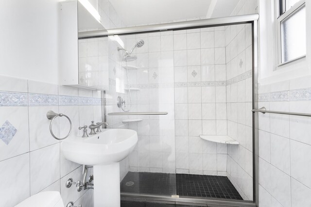 10 Huron Ave Unit 17F, Jersey City, NJ 07306 - full bath with tile walls, a shower stall, and toilet
