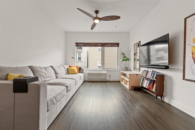 living room featuring dark wood-type flooring, ceiling fan, and a wall mounted AC