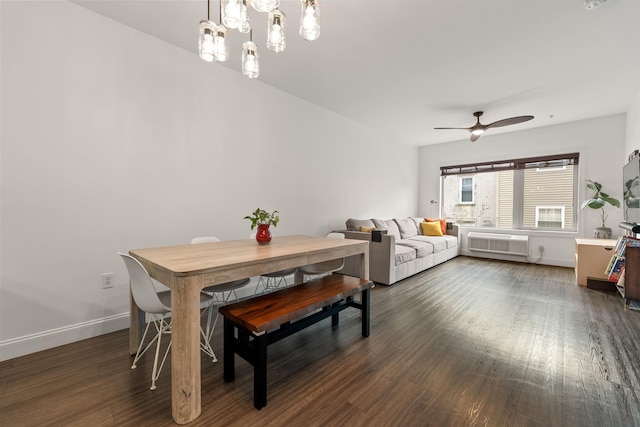 dining room featuring dark hardwood / wood-style flooring, ceiling fan with notable chandelier, and a wall mounted AC