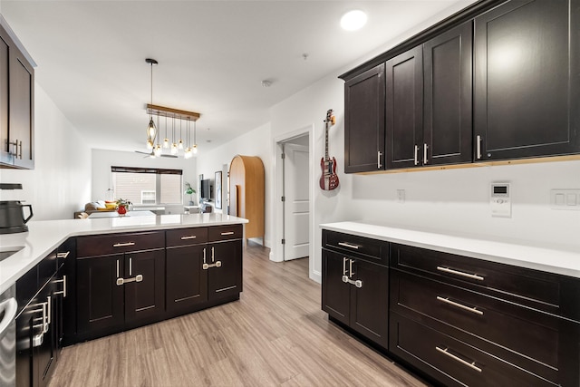 kitchen featuring dark brown cabinetry, dishwasher, light hardwood / wood-style floors, and decorative light fixtures