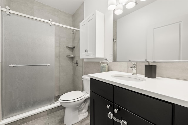 bathroom with vanity, toilet, and walk in shower