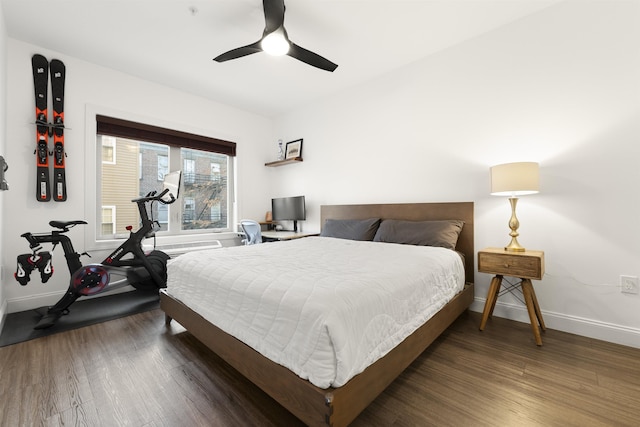 bedroom with dark hardwood / wood-style floors and ceiling fan