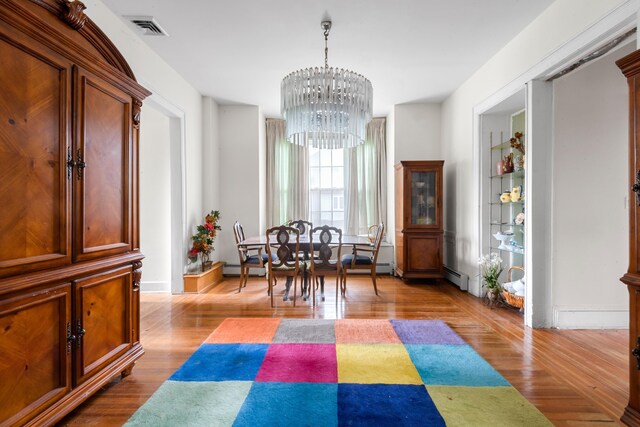 1208 River Rd, Edgewater, NJ 07020 - dining space with a notable chandelier, wood finished floors, visible vents, and baseboards