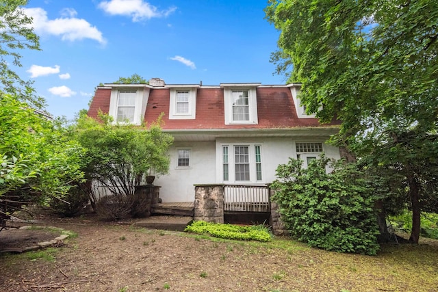 1208 River Rd, Edgewater, NJ 07020 - back of house featuring a shingled roof, mansard roof, and stucco siding