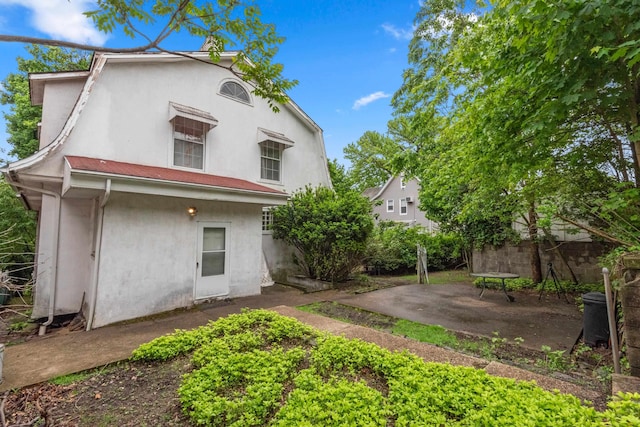 1208 River Rd, Edgewater, NJ 07020 - back of house featuring stucco siding, a patio, and fence