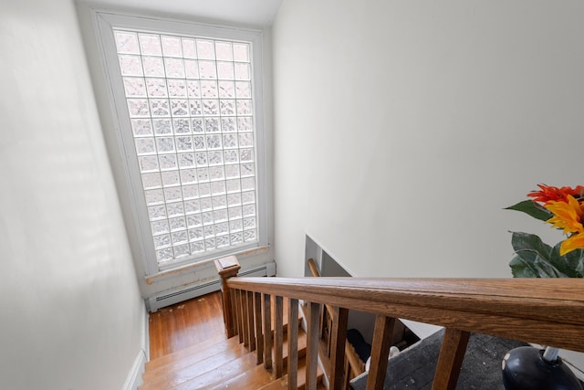 1208 River Rd, Edgewater, NJ 07020 - stairway with baseboard heating and hardwood / wood-style flooring
