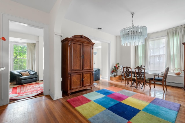 1208 River Rd, Edgewater, NJ 07020 - dining room featuring a notable chandelier, visible vents, and hardwood / wood-style flooring