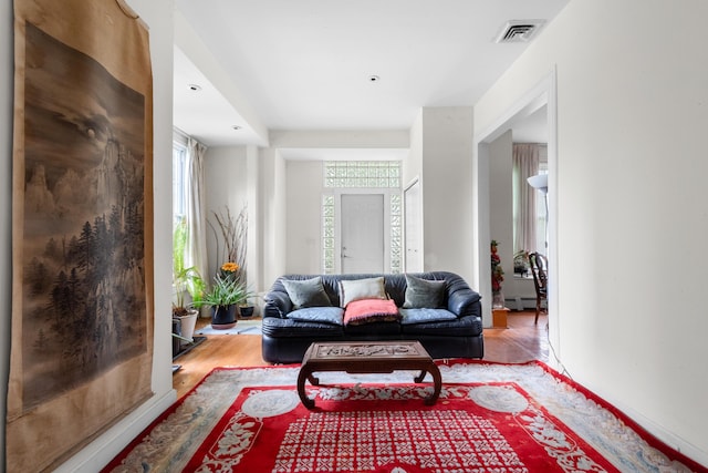1208 River Rd, Edgewater, NJ 07020 - living room featuring visible vents, a baseboard heating unit, and wood finished floors