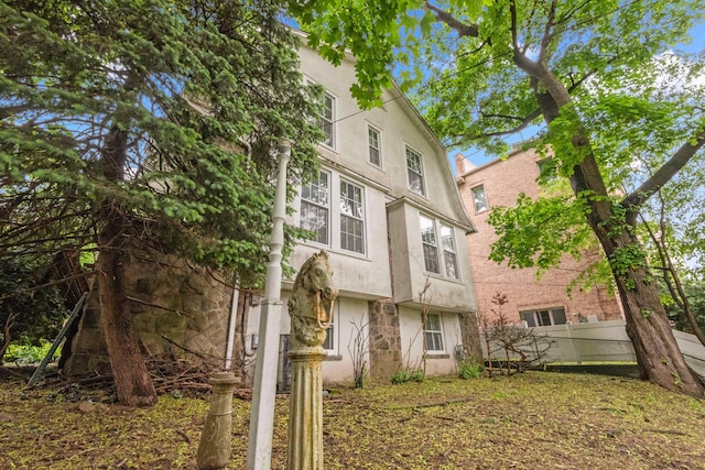 1208 River Rd, Edgewater, NJ 07020 - rear view of property with stucco siding and fence