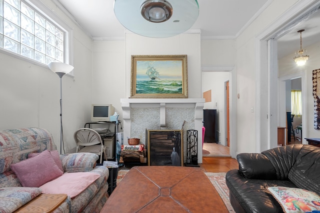 1208 River Rd, Edgewater, NJ 07020 - living room featuring a tiled fireplace, wood finished floors, and ornamental molding