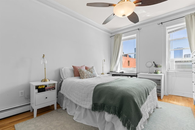 109 Erie St Unit 4L, Jersey City, NJ 07302 - bedroom with baseboard heating, crown molding, light wood-style floors, cooling unit, and a ceiling fan