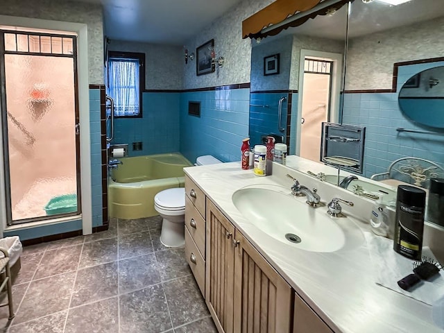 bathroom featuring tile walls, toilet, a bathtub, and a shower