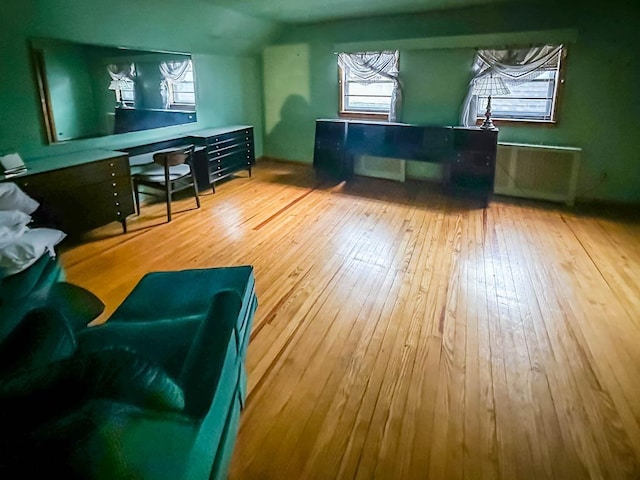 interior space with hardwood / wood-style flooring and lofted ceiling