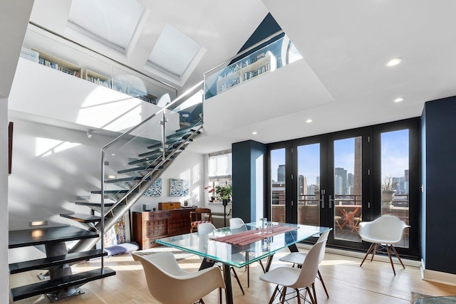 300 Newark St Unit 8G, Hoboken, NJ 07030 - dining space featuring stairs, light wood-style floors, french doors, a towering ceiling, and recessed lighting