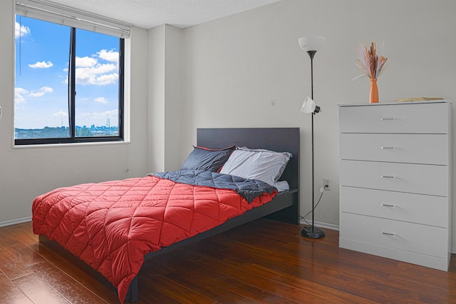 Harmon Cove Tower 426, Secaucus, NJ 07094 - bedroom with wood-type flooring, multiple windows, baseboards, and a textured ceiling